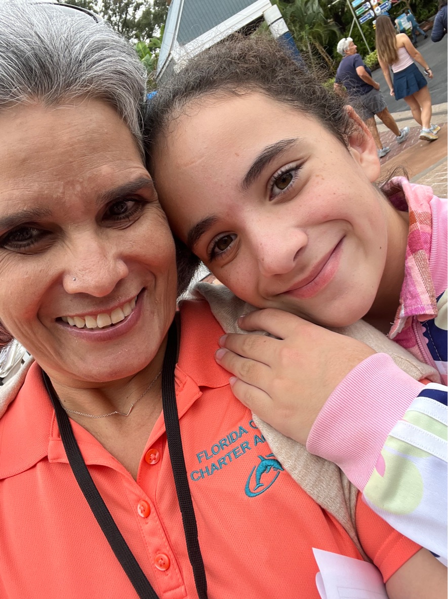 Girl with teacher in the zoo