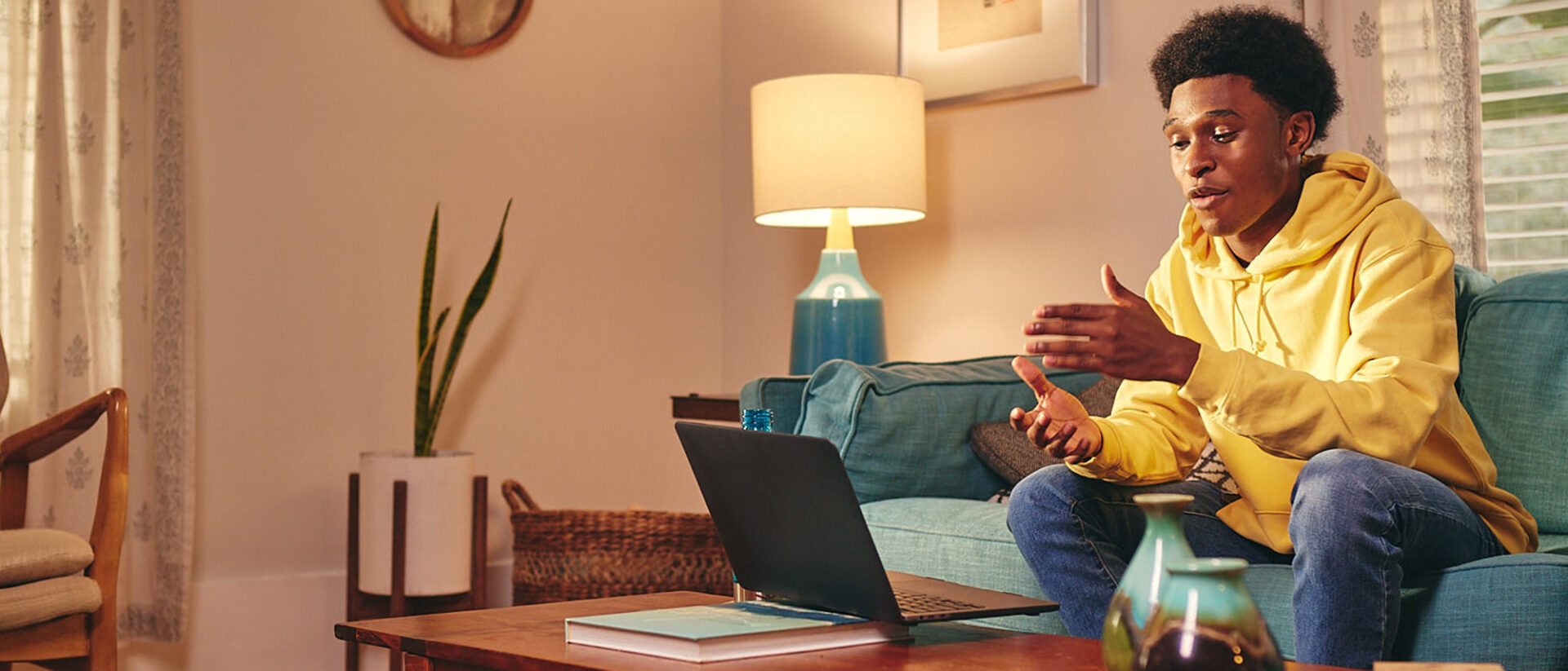 Student talking to his online class at home