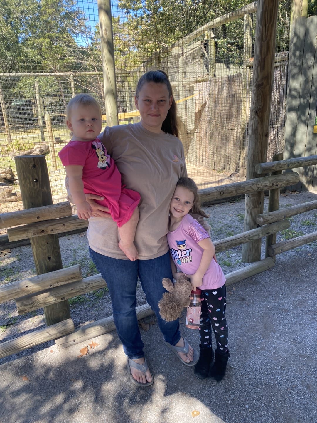 baby with mom and other girl in the zoo