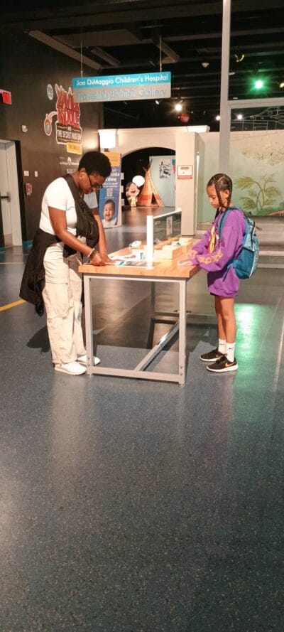 mom and girl playing at the museum